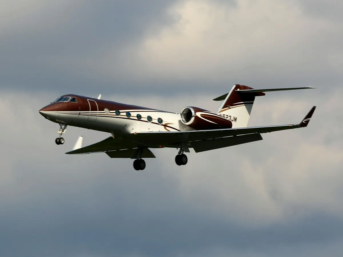 Business jet in flight among clouds