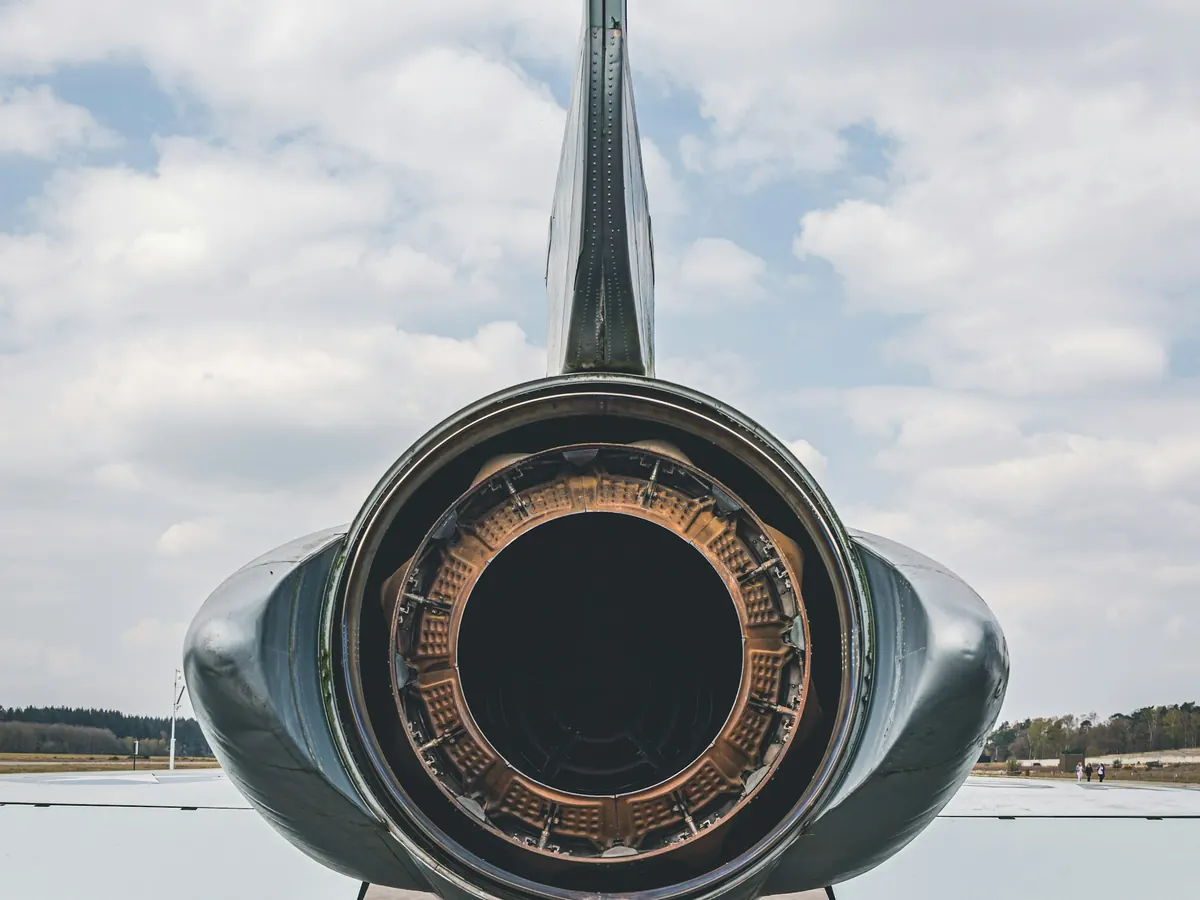Rear view of a small jet’s engine and tail on the ramp